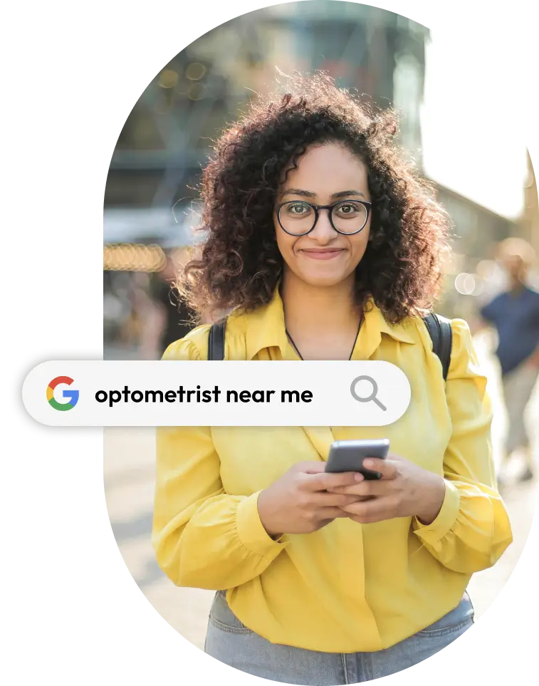 Young woman in yellow shirt searching 'optometrist near me' on her smartphone while standing outdoors.